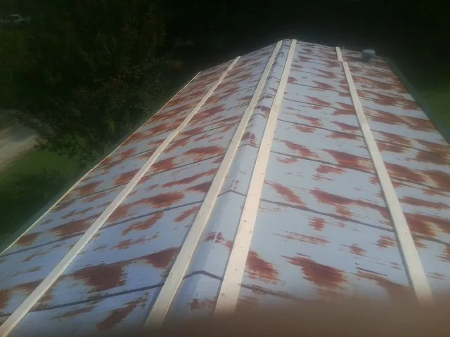 Rusted metal roof panels with new wood purlins before replacement — Storm Damage Roof Repair in Orford by Roofing Brothers