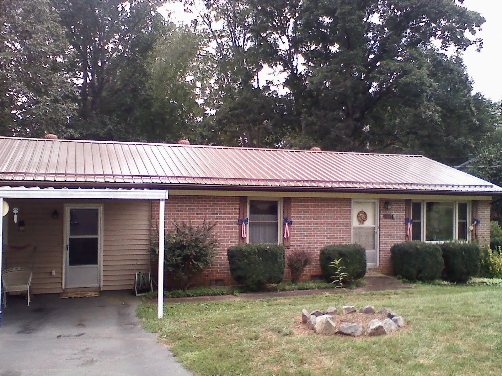 Bronze metal roof and carport on a brick ranch home — Roof Repair work by our crew in Orford