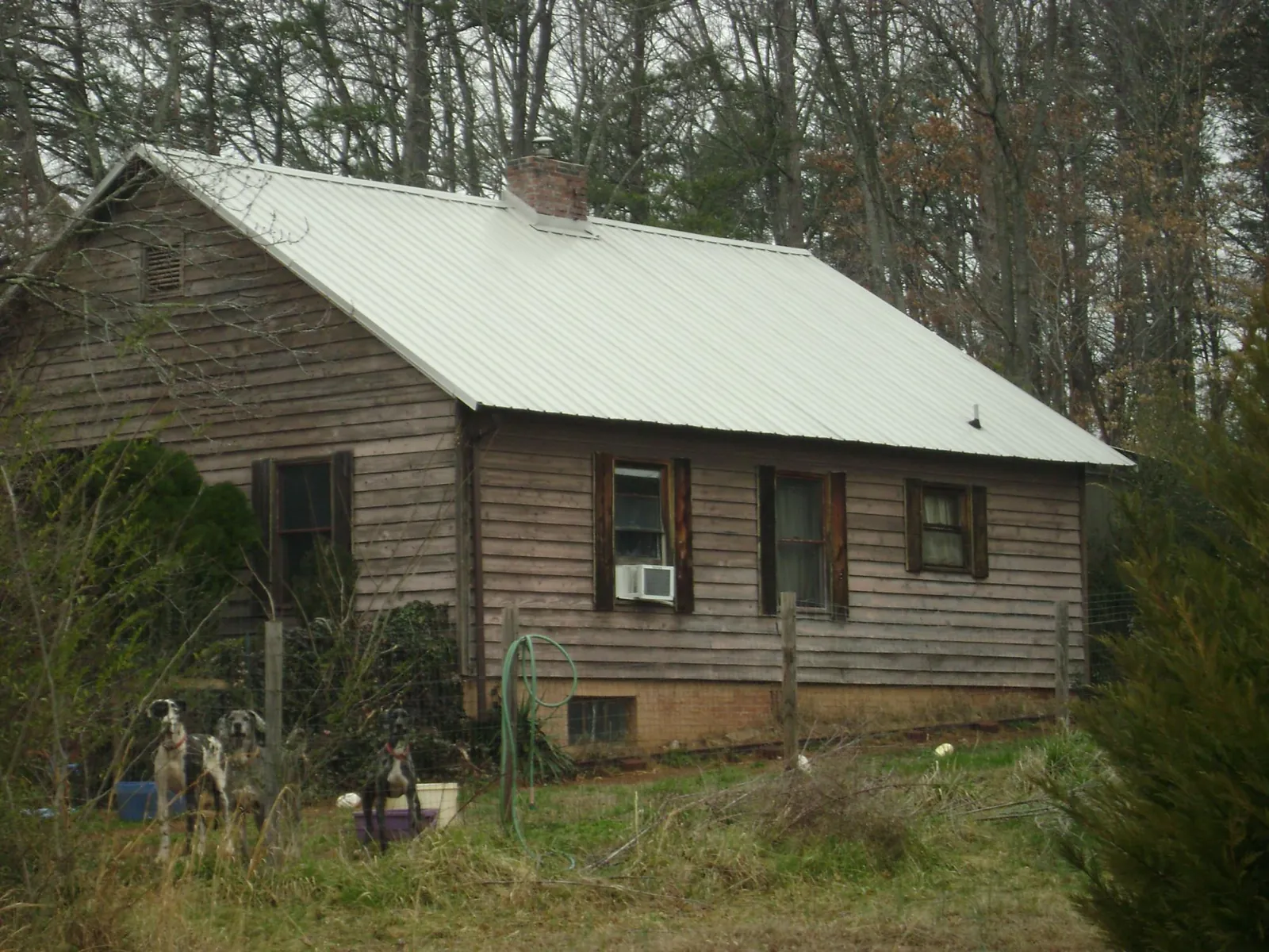 White metal roof on an old wood sided farmhouse, from a Metal Roof Installation job in Orford